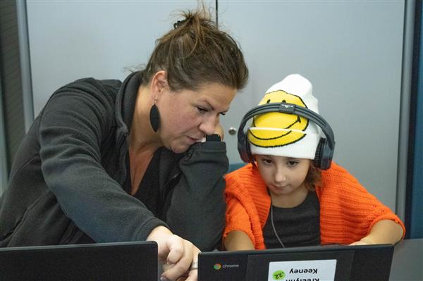 Mrs. Keesey assists students with their Digital Literacy work.