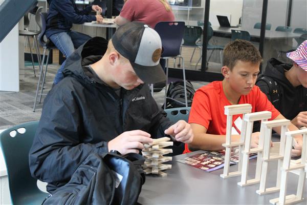 Students work to build structures with Keva Planks.